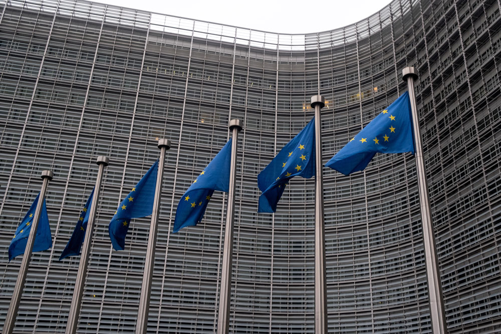 low-angle-view-flags-hanging-against-building